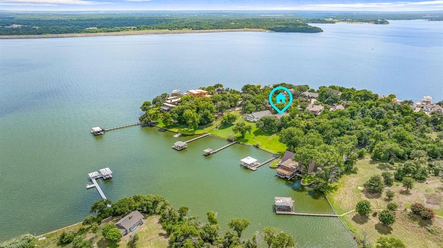 'COME SAIL AWAY' on Texas's #1 sailing lake-Eagle Mountain Lake. This home is waiting for new creative ideas to make it a top Estate on arguably one of EML's top 3 streets. This .70 acre, over 4100 sqft., 5 bedrooms-4 baths, over 100' water frontage, and deep water at the dock are just a few of the benefits this property has to offer. There is a separate workshop with an office above for quiet time or naps. If your knees are shaking because of the potential vision of what can be created, there is an elevator that can get you to the different levels. The nationally recognized Fort Worth Boat Club is a 4-5 minute boat ride or car drive away. If you do the updating, the possibilities are endless for a family lakeside Revival Resort. Enjoy living on a street where Eagles, Beatles, and John Denver ('come fill up your senses') have visited, and the Fort Worth Star Telegram has done articles on the impressive history of ownership of Dickson Road. The 'Crystal Blue Persuasion' will keep your blood pressure at a perfect level. Relax on the lakeside decks in the Hot Tub and become 'Comfortably Numb'. Come Explore For Additional Benefits Hidden In Plain Sight. This property is a 'catch' worth bragging about. 
Eagle Mountainonians have a saying that this beauty will get you so excited and tongue-tied you will not be able to CLINK THEARLY!! Call if you don't get this, and we will also set up a showing!