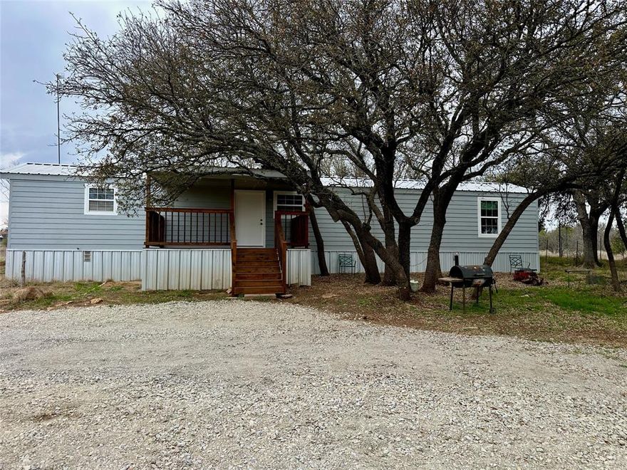 Great opportunity to own a home on acreage near Lake Brownwood. This single wide mobile home sits on approximately 1.23 acres at 6535 Field Dr. in Brownwood, Texas. Note that many map services show the street name as Valley View Drive, but the physical address is Field Drive.

Built in 1984, the home offers about 924 square feet of living space with two bedrooms and one bathroom. Recent updates include fresh interior paint, newer flooring, an updated kitchen, and a remodeled bathroom featuring a step in shower. The home also includes electric central heat and air for year round comfort.

The kitchen provides good cabinet storage along with a pantry and comes equipped with an electric range, built in microwave, and dishwasher. Both bedrooms feature newer ceiling fans for added comfort.

A covered front porch or deck measuring approximately 160 square feet provides a nice place to relax and enjoy the peaceful surroundings.

The property includes two storage buildings that offer plenty of extra space for tools and equipment. One is a wood frame storage building measuring about 247 square feet, and the other is a 160 square foot metal building.

The 1.23 acre lot is a major advantage, providing space, privacy, and flexibility with no known restrictions. Whether you want room for outdoor projects, gardening, or additional improvements, the property offers plenty of possibilities.

Another highlight is the location. Lake Brownwood is only about one mile away, making it easy to enjoy boating, fishing, and outdoor recreation. The property is also approximately 10 miles from Brownwood, giving convenient access to shopping, dining, schools, and medical services while still enjoying a quieter country setting.

If you have been looking for an affordable home with acreage close to Lake Brownwood, this property is worth a look.