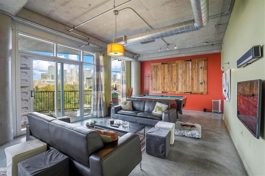 This stylish loft style condominium in a secure high rise features floor to ceiling windows with breathtaking views of the downtown Dallas skyline, Union Tower, and the building's pool. The interior boasts polished concrete floors, two bedrooms, two full baths, and a versatile office nook. The kitchen features stainless steel appliances including an updated built in microwave and an updated dishwasher. The washing machine and dryer both stay with the home and the pool table stays at no additional cost. The brand new refrigerator, television, and soundbar are all negotiable. This unit includes two designated covered parking spaces. Located in the popular Cedars at The South Side, you are steps away from local hotels, theaters, and the Cedar Dart Station. Monthly HOA includes insurance, water, sewer, trash, and the electricity used by the central chiller, keeping electric bills low.