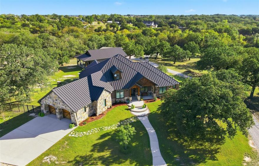 Experience luxury, country living at its finest in this custom-built home on 10.1 picturesque acres. The main house offers 3,034 sq. ft. of living space while the guest house adds 1,260 sq. ft., for a combined 4,294 sq. ft. Thoughtfully designed and built in 2016, this property offers beauty, functionality, and craftsmanship at every turn. The land is ag exempt, fenced and cross-fenced with a lean-to for livestock, complete with scenic trails, a dry creek bed, and a waterfall that flows during wetter seasons, creating a truly serene backdrop. 

Inside, the 3-bedroom, 3-bath main home features an open floorplan filled with natural light and oak hardwood floors throughout the main living spaces. Spacious secondary bedrooms have walk-in closets and a jack-and-jill bath. The study is ideal for remote work, boasting custom built-ins and abundant shelving.

The chef’s kitchen impresses with solid oak cabinetry, granite countertops, a kitchen island, double ovens, built-in gas range, and a cozy breakfast nook. A wood-burning, stone fireplace anchors the open living room, perfect for gathering and relaxation. The oversized laundry room connects to the primary bathroom for convenience and includes a sink and built-in cabinetry, while a safe room with a steel door and reinforced cinder block walls add peace of mind.

Step outside to the covered patio overlooking a sparkling saltwater pool and spa—the ideal spot to unwind and enjoy the view. A separate 1-bedroom and 2-bathroom guest house provides a private retreat for friends or extended family. 

The property also features a 600 sq. ft. insulated workshop with two bay doors, electricity, and a covered area for tractor parking. Additional highlights include a Class 4 metal roof, spray foam insulation, an engineered slab with 78 piers extending 23 feet deep. Paradise ISD schools.

Please see the transaction desk for a complete list of features—this is one you won’t want to miss!