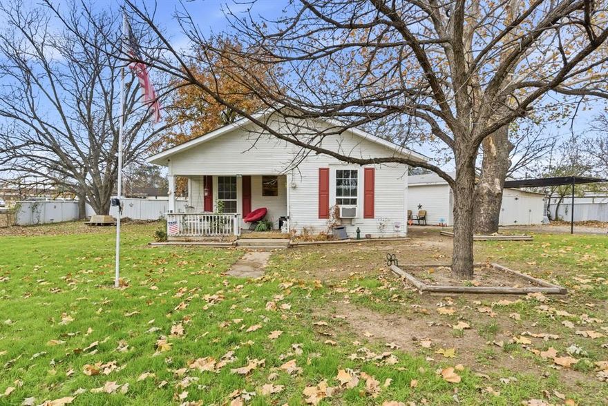 Step into timeless charm with this adorable 2-bedroom, 1-bath home featuring a classic 1920s feel and character you just can’t replicate! From the moment you arrive, you’ll love the inviting front porch—perfect for morning coffee or evening unwinding. Inside, the home offers two bedrooms plus a flexible bonus space that could serve as an optional 3rd bedroom, office, den, or hobby room to fit your needs. Some new windows, updated kitchen, some updated plumbing has been done.  Sitting on a large lot with plenty of room to spread out, this property also includes an attached workspace with electricity—ideal for projects, storage, a small shop setup, or creative studio space. Priced right and full of potential, this charming home is ready to be enjoyed!
