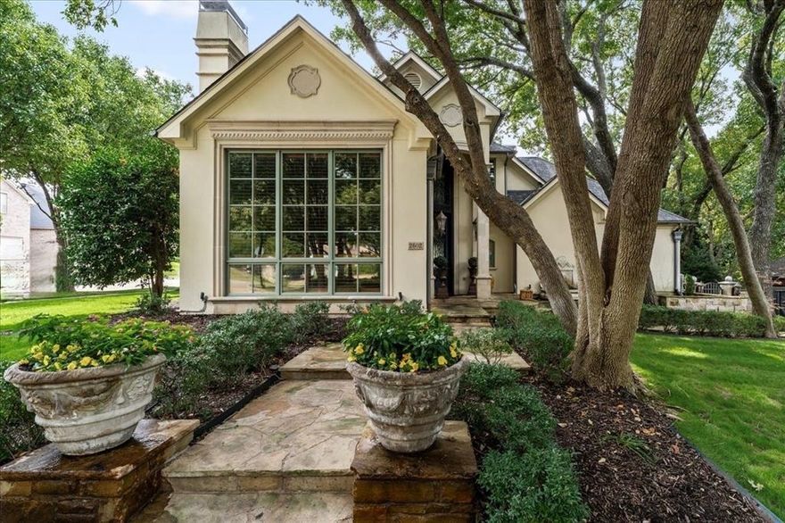 Tucked beneath mature trees on coveted Woods Lane, this reimagined custom residence blends timeless architecture with magazine-worthy finishes and resort-style outdoor living. Rebuilt inside and out in 2006 with exquisite craftsmanship, the home showcases 4,570 sq ft with 4 bedrooms, 3 full baths and 2 half baths, and a versatile layout designed for both grand entertaining and everyday ease.  
Inside, multiple living and dining spaces flow across hand-scraped and Versailles-pattern hardwoods and stone in a palette of rich textures and natural light. The chef’s kitchen centers the home with flanking Sub-Zero refrigeration, custom cabinetry, and Versailles-pattern stone flooring that continues to the outdoor living areas—seamlessly connecting kitchen, breakfast, and patio for effortless gatherings.  
Upstairs, three secondary bedrooms and two full bathrooms accompany a massive game room.  Throughout the home you’ll find cast-stone fireplaces, decorative lighting, plantation shutters, and thoughtful built-ins that elevate daily living.
Outdoors is a private sanctuary: a 45' x 22' stone terrace anchored by an Austin-stone fireplace with gas starter, lush landscaping with stone walkways, and a large spa with waterfall for year-round enjoyment. The insulated garage includes a floored attic for easy, organized storage.
Positioned on approximately 0.38 acres in the- SpringPark community—known for its clubhouse, pool, tennis, private lake-pond, greenbelt, and miles of trails. You are moments from- PGBT and 190, Cityline, Richardson’s tech corridor, and Richardson acclaimed ISD schools.