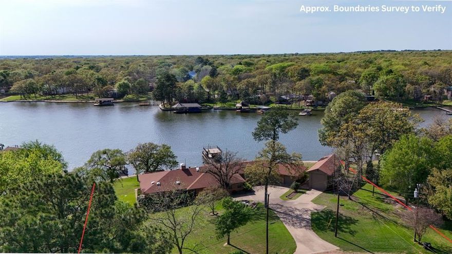 Welcome to an exceptional lakefront retreat on three expansive waterfront lots totaling approximately ¾ of an acre, featuring 242 feet of shoreline in a deep water cove protected from wind and waves—ideal for boating, swimming, and lakeside living. This well-maintained home offers 4,833 square feet with 5 bedrooms, 4 full baths, and multiple indoor outdoor spaces. The main level 3,667 sq ft includes a large kitchen and dining area with island seating, double ovens, cooktop, and abundant cabinetry and counter space. A spacious living room with vaulted ceiling and fireplace opens to a sitting area and wet bar. Two en suite bedrooms are on the main floor, including a lakeside primary suite with sitting room and luxury bath featuring dual vanities, separate jetted tub and separate shower and walk-in closets. Three additional bedrooms and bath complete the main level. The lower level 1,166 sq ft features a large bonus game room, full bath, and 2 flexible rooms ideal for a gym, office, wine cellar, hobby space or sleeping space. Ample storage is available throughout, including under the home. Enjoy a covered lakeside deck with sunset views and peaceful water vistas. Whether you're launching kayaks or paddle boards from the concrete ramp, swimming with the kids, or letting pets enjoy the water, this property is designed for fun, function, and flexibility. Two boathouses enhance the waterfront lifestyle—one with a party deck and space for 2 personal watercraft, the other with a boat slip and room to expand or add a third TRWD permit. Additional features include a 3-car garage with HVAC’d workshop and an enclosed RV garage with electric hookup, offering space for boats, vehicles, and water toys. Located near Pinnacle Golf & Country Club, with golf and social memberships available, this rare property offers exceptional lot size, privacy and water access. Updates include two new 5-ton HVAC units 2021, aerobic septic 2016, and retaining wall 2023.