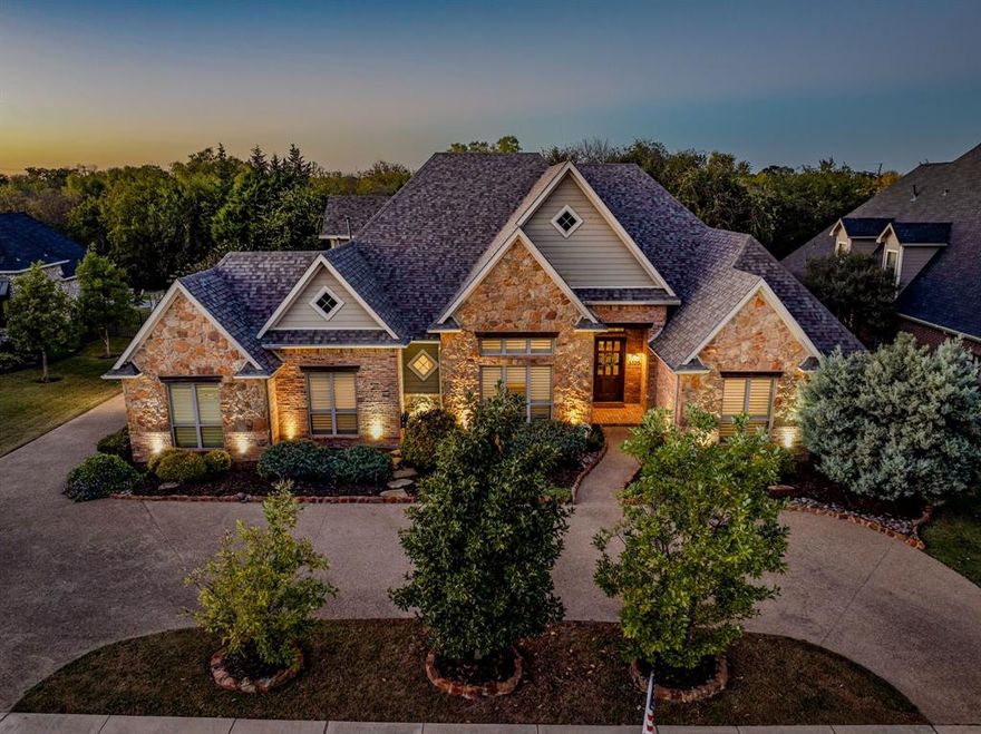 This former Carmen Custom Homes model is far more than a house; it is a private retreat that blends elegance, comfort and the very best of indoor and outdoor living. Set on the peaceful northeast edge of the community, the property enjoys an enviable location backing to a lush, tree filled greenbelt and meandering creek. From the moment you step outside, the natural surroundings create a sense of calm and privacy that is rarely found and provide a picture perfect backdrop for entertaining or quiet relaxation. Your backyard is a true resort. The sparkling saltwater pool with a swim up bar and spa invites you to cool off on warm Texas afternoons or soak under the stars at night. An outdoor kitchen makes hosting easy, while the cozy fireplace and firepit extend your living space well into the evening and create the perfect setting for unforgettable gatherings with friends and family. Inside, thoughtful design and timeless character greet you at every turn. Antique brick floors add warmth and texture and the chef’s kitchen is a dream come true. An oversized island with bar seating, a gas cooktop, dual ovens and a built in refrigerator make everyday meals and special celebrations a pleasure. All four bedrooms are thoughtfully placed on the first floor for effortless living and ideal for multi generational needs. The primary suite is a true retreat with a spacious closet that connects directly to the laundry room and an adjoining flex space that works beautifully as a private office, nursery, gym or even a fifth bedroom. Upstairs, a generous bonus room offers endless possibilities from media or game space to a creative studio. With quick access to Denton Country Club and Liberty Christian School you can enjoy unmatched convenience along with the luxury and serenity of this remarkable home. Schedule your private showing today and experience why this property captures the very best of Argyle living.