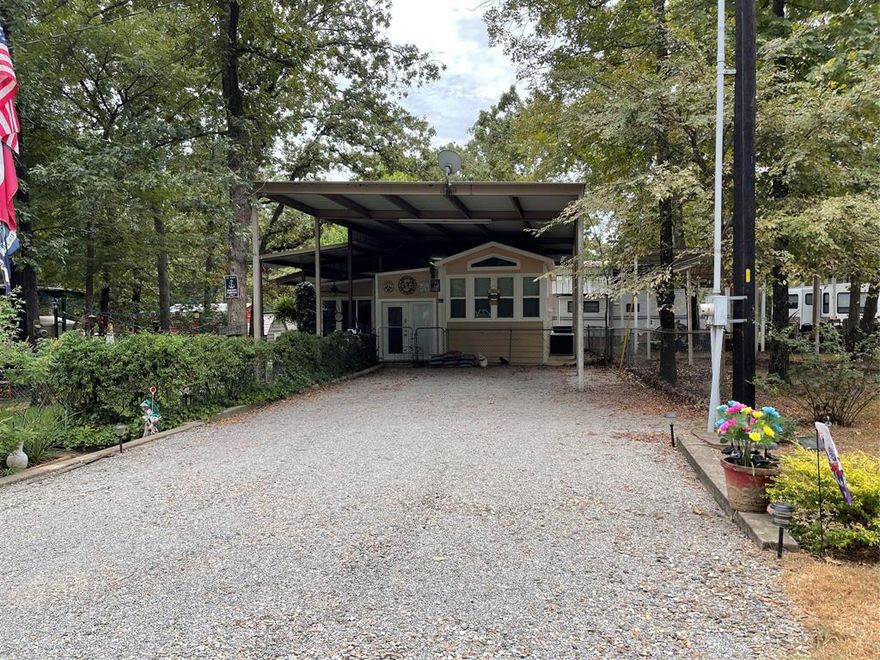 Located in the highly desirable community of White Oak Shores on the World Famous Lake Fork.  This property boasts 4 spacious adjoining lots.  There is a spacious park model that has a large 18x33 living room addition.  The park model features a cozy bedroom, full sized kitchen and a spacious bath with double shower.  On the adjacent lots there is an oversized metal cover that can fit multiple boats or an RV.  In addition there a 2 storage buildings.  There yard is so relaxing with the fire pit and garden and it is completely fenced with chain link.  White Oak Shores features a private boat ramp and dock, community facilities and a community pool for homeowners use.