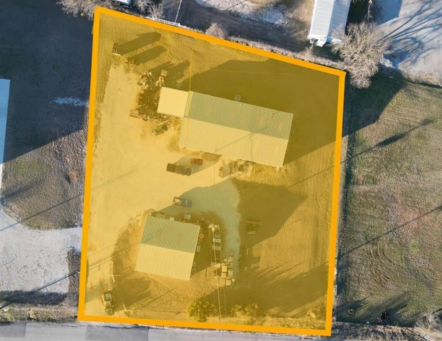 Versatile commercial property on ~1 acre at TX Hwy 199 & Goshen Rd. Includes a 4,000 SF main building plus 1,600 SF office, grade-level dock, and three-phase power with central HVAC & ventilation. Zoned C-2 with outside storage and gravel parking—ideal for light manufacturing, warehouse, or service operations.