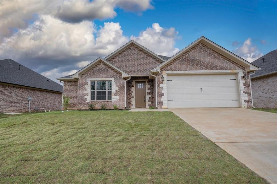 Energy efficient brand new construction on an easy to maintain lot in Lindale ISD. This home offers luxury vinyl plank flooring throughout the main and wet areas, with carpet in the bedrooms. The open living space has a gas fireplace complete with gas logs, breakfast area, and is open to the kitchen with granite, custom cabinets and stainless steel appliances, including a gas range! The owners suite has an attached bath with granite counter tops and walk in shower. The two guest rooms and second bath, with granite and tub-shower combo, are separate from the owners suite. The covered back porch leads to the fully fenced backyard. There is a full sprinkler system and sod front and back. The community is curb and gutter and offers a 7 acre greenspace, landscaped entrance, sidewalks and streetlights, PLUS a location with convenience to I-20 and Loop 49, making the drive to Dallas, Shreveport and Tyler a breeze.