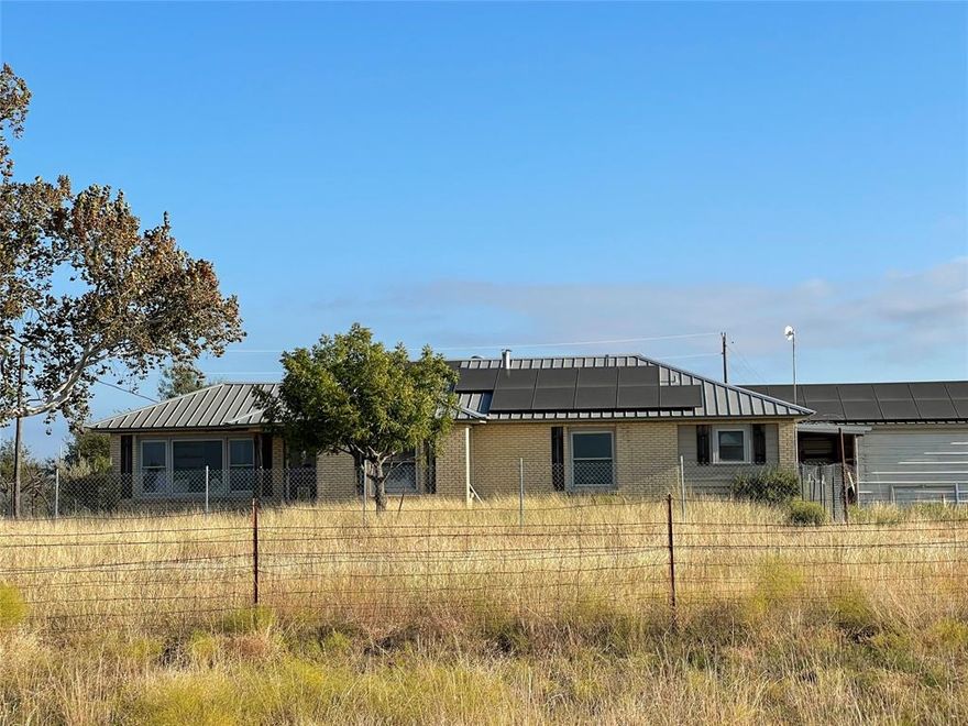 Nice property located on the edge of Hamilton on paved FM 1241.  This is a distressed property that needs extensive clean extensive clean-up after a seller financed foreclosure.  The home is a solid older brick home that was completely renovated several ago that included metal roof, vinyl windows, refinished original wood floors, large game room or den with tile floors and wood stove.  This home has 252 sq ft of living  area with 3 bedrooms and 2 baths.  The home site back off of the road on a hill with very nice views across the native grass pasture leading down to a small pond.  There are enough trees at the back of the property to support some wildlife and offers decent hunting.  The property is fully fenced and has good native grass for grazing livestock.