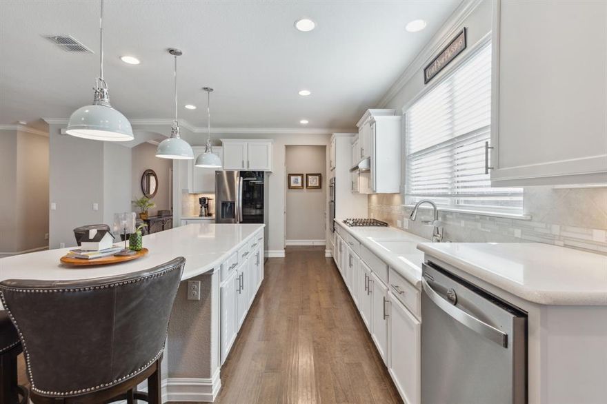 Beautiful Martin Ray plan loaded with $110K in upgrades in desirable Frisco Lakes! Chef's kitchen includes gas cooktop, single basin sink, upgraded Whirlpool appliances, huge island w designer lighting, quartz c-tops, abundant storage, butlers pantry & large walk-in pantry w spice rack. Living room  tray ceilings, recessed lighting, fan & cozy gas fireplace. Bright sun room leads to a charming outdoor retreat w statement patio cover featuring cedar ceiling, ceiling fans, recessed lighting & impressive stone columns. Spacious owner's suite + ensuite bath with step in shower with seat, dual sinks & large walk-in closet. Oversized garage w epoxy floors, abundant overhead storage & golf cart parking! Addtl features: Wood floors, crown molding, ceiling fans throughout, landscaped flowerbeds & iron fenced yard. Active 55+ community with 3 amenity centers, outdoor pools, fitness center, club rooms, pickleball, tennis & Bocce ball courts, walking trails, a golf course & much more!