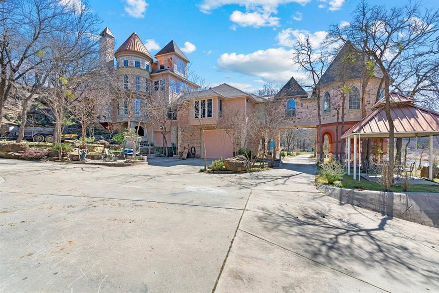 This breathtaking castle-style estate on 10.97 acres in Chico, TX, offers unparalleled luxury, privacy, and outdoor adventure with direct river access and a private boat ramp. The 5,981 sq. ft. main residence features 6 bedrooms, 3 bathrooms, and a 3-car garage, all designed with elegant finishes and expansive living spaces. A detached indoor pool oasis with a spa and private restroom provides year-round relaxation, while a 2-bedroom, 1-bath guest house with a 2-car carport offers additional accommodations. The estate is perfect for entertaining with its outdoor pavilion, and the private boat ramp makes it easy to enjoy boating, fishing, and kayaking on the river. Surrounded by breathtaking waterfront views and peaceful natural surroundings, this one-of-a-kind property is the perfect blend of luxury and outdoor living.