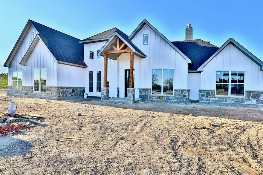 Wossum Ranch is ALWAYS in HIGH DEMAND! Go see this brand new Castlemont Home loaded with high end upgrades! From the front door all the way through you’ll find a never-ending list of super premium finishes! Iron front door, gorgeous stacking 12’ patio door unit, vaulted great room ceiling with decorative beam work, a towering dining room ceiling with awesome feature wall trim work, butler pantry, kitchen cabinet uppers extended up to the 10’ ceilings, master suite feature wall with decorative trim work, shiplap style siding in master bath and on the great room fireplace, granite faced fireplace, waterfall style kitchen island, and more. Back patio offers abundant privacy and 1-acre lot provides plenty of space to stretch out! Craftsman style trim work and shaker style custom cabinetry throughout. Guest bath provides both inside and back patio access perfect should you add a pool later. Master closet passes through to utility for convenience. Drop by and see it today!