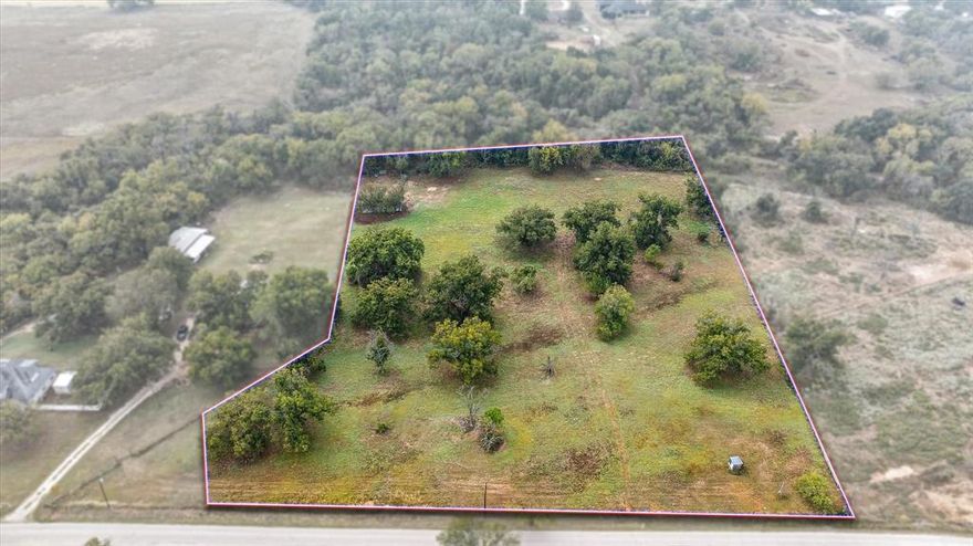 4.661 Acres with Beautiful Trees, Fenced, and Ready to Build! Discover the perfect blend of privacy, beauty, and convenience on this 4.661-acre tract featuring mature hardwood trees, full fencing, and utilities already in place. Enjoy co-op water, city sewer, and access to a community water well, making your future build hassle-free. The property backs up to a gorgeous greenbelt, offering a serene natural backdrop and a touch of country charm right at your back fence—25 x 40 metal barn in place for your animals or for storage. A small portion of the land lies within the floodplain, providing the unique opportunity to enjoy the natural flow and character of the creek without compromising build potential. Located in an ideal spot—10 minutes to Azle, 20 minutes to Weatherford, 25 minutes to Fort Worth, and less than an hour to the heart of the DFW Metroplex—this property offers the best of both worlds: peaceful country living with easy access to shopping, dining, and major highways. Perfect for your dream home, barndominium, or weekend retreat. Springtown ISD.