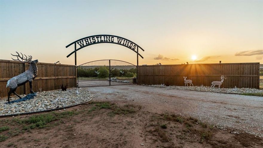 Whistling Winds Ranch is one of the most unique and breathtaking properties in North Texas. From dramatic elevation changes to custom-built lodges and lakes, every aspect of this ranch captures the true essence of luxury, recreation, and adventure.

The ranch features a one-of-a-kind 80’ x 80’ barndominium lodge that serves as both a comfortable retreat and a fully functional headquarters. With 2,000 square feet of living space, this lodge includes a trophy-lined great room, an impressive rock bar with a commercial-grade cooler and ice maker, and two guest suites with private baths. The wrap-around porches and outdoor firepit provide the perfect setting for entertaining or relaxing after a long day outdoors. The adjoining 60’ x 80’ insulated shop area offers four automatic rollup doors, industrial shelving, and ample storage.

Just west of the lodge, the custom cedar main residence overlooks the scenic Devils Creek canyon. The home features three bedrooms, a loft, three baths, vaulted ceilings, a wood-burning stove, and expansive windows showcasing the landscape. Its open kitchen with granite countertops and premium appliances makes it ideal for entertaining, while covered porches on the east and south sides offer stunning sunrise and sunset views.

The ranch’s terrain boasts over 200 feet of elevation change, unveiling canyons, creek bottoms, and sweeping views of the Pease River Valley. Three beautiful lakes—Devils Creek, Rock Lake, and a newly constructed western lake—offer incredible fishing and scenic tranquility.

Whistling Winds Ranch is high-fenced and home to an extraordinary mix of native and exotic wildlife including whitetail, mule deer, elk, red stag, fallow, aoudad, oryx, and more. With extensive road systems, food plots, and premium blinds and feeders, the property is turnkey for hunting, recreation, or private enjoyment.

This exceptional ranch combines luxury, functionality, and unmatched natural beauty—making it a true North Texas gem.