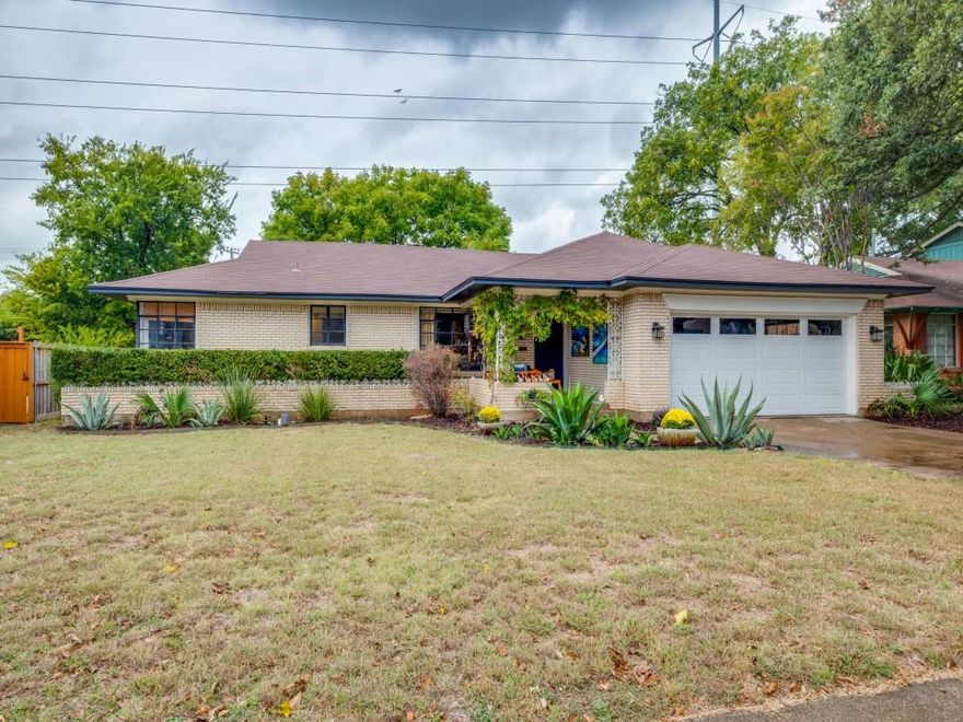 Alger Park Mid-Century Ranch. Welcome to this inviting mid-century modern brick ranch in the heart of Alger Park, one of Dallas’s most loved and tree-lined neighborhoods. Set on an oversized lot with alley access, this home offers space, character, and charm that are increasingly hard to find.
A large covered front porch welcomes guests and creates the perfect place to enjoy morning coffee or quiet evenings. Inside, you’ll find beautiful hardwood floors throughout, a sunny eat-in kitchen, and a separate dining room ideal for gatherings and everyday living.
One of the standout features of this home is the expansive art studio — a rare and inspiring space with endless possibility. Whether you envision a creative workspace, playroom, private office, or a luxurious primary suite conversion, the footprint and flexibility are already in place.
The huge backyard provides room to relax, entertain, garden, or expand — plus plenty of space to add a two-car garage or guest quarters with convenient access off the alley.Perfectly located just minutes from the Dallas Arboretum, White Rock Lake, beloved local shops and eateries, and with quick access to Downtown and the city’s museums, theaters, and cultural destinations — the lifestyle here is as desirable as the home itself. Lovingly maintained over the years, this residence is ready to enjoy as is — or to personalize with your own design vision. An incredible opportunity in a truly special neighborhood.

Buyer and Buyer's Agent to verify all listing details.  Info is deemed accurate, but is not guaranteed.
