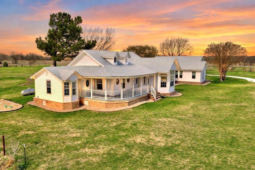 Stunning Bosque County Country Retreat on 2.75 Acres in Clifton ISD, just outside of town!
*PLEASE NOTE: THE MAIN HOME IS ONLY 5 YEARS OLD! Tax records show this home being built in 1945. The right side is the original home built in 1945 and is now the additional living area, which has all been updated. The main house was completed in 2021 and not lived in until then. The home is virtually brand new!
Welcome to your dream home nestled in a sought-after area just outside of Clifton, beautifully designed with 3,613 SF, 5 bed, 3.5 baths, additional private living area, great for multi-generational living or hosting guests. Situated on a low maintenance secluded lot, this property offers privacy, serenity, and endless possibilities. Inside be welcomed by timeless craftsmanship, walk in closets, expertly crafted crown molding, wainscoting, custom windows, marble finishings, herringbone flooring, recessed & custom lighting in and out, brand new carpet in all bedrooms adds comfort. The kitchen is ready to serve, complete with all appliances included, open floor plan flows easily into multiple living spaces—ideal for both entertaining and everyday living with plenty of room to stretch out! Peace of mind with brand new septic, 2 brand new water heaters  and 2 HVAC units-one just a year old, a security system only 2 years old. Outside experience true Texas charm with a wrap-around covered porch, perfect for enjoying sunrises, sunsets and peaceful country views. The property is fully fenced with a private electric gate and features a 6-car carport with electricity, an enclosed barn-workshop with power, and an air-conditioned outbuilding ideal for a home office, she shed, playroom or creative studio plus 2 additional shipping containers for storage. This one of a kind property combines luxury, function, and flexibility for guests or multi-generational living—offering a peaceful country lifestyle just minutes from all the conveniences of Clifton.