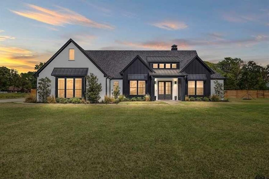 This stunning 4-bedroom, 3-bath home offers a spacious, thoughtfully designed layout with versatile bonus spaces ideal for entertaining, a home office, or flexible living. From the moment you step inside, you’re greeted by soaring vaulted ceilings, abundant natural light, and elegant finishes throughout. Designer details include custom cabinetry, high-end fixtures, and dimmable lighting that create the perfect ambiance in every room. The open-concept living area flows seamlessly into a chef’s dream kitchen featuring commercial-grade appliances, an oversized refrigerator, and double ovens—perfect for hosting gatherings of any size. A split floor plan provides a private owner’s suite retreat, separate from guest bedrooms for maximum comfort and privacy. Upstairs attic access offers excellent storage and an exciting opportunity for conversion into additional living space or a bonus room. Situated on nearly 6 acres, this property boasts the largest lot in the highly desirable Blue Ridge Estates and showcases peaceful water views of Lake Palestine. Outdoor amenities are equally impressive, including a spacious back porch ideal for entertaining and a beautiful in-ground heated pool for year-round enjoyment. The long, wide driveway allows for ample parking, making hosting effortless, while the additional acreage provides space for recreation and guests. Two additional adjacent lots are also available for purchase, offering approximately 3 extra acres—perfect for expanding your estate or enhancing privacy. Adding to its charm, this is the only property in the neighborhood permitted to have chickens, enhancing its serene country feel. Located minutes from the marina and within sought-after Bullard ISD, this home offers convenient access to Tyler while maintaining peaceful privacy.