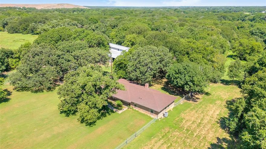 SERENE LAND and COMPLETELY RENOVATED HOME awaits its NEW OWNER! Nearly 30 acres just seconds from I-35. This COUNTRY PROPERTY boasts Beautiful and Peaceful Features- Post Oak & Pecan Trees - Heavily Wooded. Ginormous Barn (72 X 60) with Equipment Parking, Workshop Area and Roll up Doors - with Upstairs (that was once an apartment). Wildlife Recreation or Cattle Life, your Choice! Sheds and Pens Available for Animals and Projects.  Multiple Smaller Fenced Areas. 3 Bedroom, 2.5 Bathrooms, 2 Dining Areas and Oversized Garage. Large Living Area, Plenty of Windows for Natural Light, Covered Patio and Porch for Bird or Family Watching. HOME has been Completely Restored- Foam Insulation, New Electric, New Walls, Fixtures, Appliances and a NEW ROOF! See Private Remarks for Address- 3 parcels included. Interior Photos are Virtually Staged.