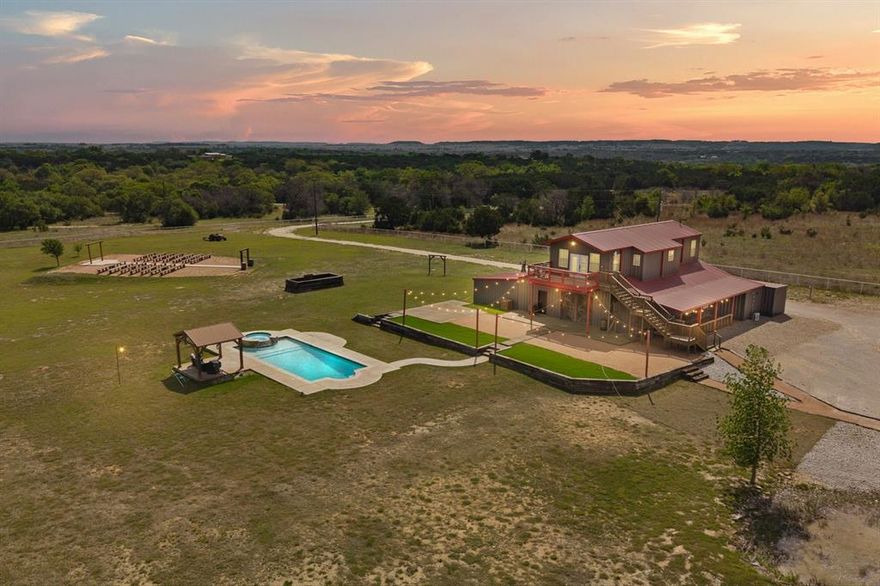 Positioned on approximately 17 acres just outside Glen Rose in Bosque County, this established event venue offers a rare opportunity to step into a thoughtfully designed space with infrastructure already in place for continued operation. Previously used as a wedding and event venue, the property is well equipped for a seamless transition or expansion of the existing concept. Or the ground work is done for your own vision! The venue features an approximately 2200 sqft reception area with a built in bar and two restrooms, each with dual stalls and sinks. Above, an approximately 1200 sqft bridal suite includes a full kitchen, living area, bedroom, bathroom, and private balcony with long range views. A separate approximately 700 sqft groom’s cabin offers additional accommodations with its own kitchen, living space, bedroom, and full bath. The outdoor space is designed for gatherings and events, complemented by a heated pool, spa, and pergola. The land features a mix of open pasture, hardwoods, and cedar, creating a private and scenic setting with minimal surrounding noise. A small water feature near the venue adds charm, while a separate low lying area offers potential for future pond development alongside a beautiful potential build site. Located within convenient reach of Fort Worth, Dallas, and Waco, the property offers accessibility while maintaining a secluded feel. Parking for approximately 75+ vehicles with room to expand is already in place. Venue holds approximately 150 guests. With no known restrictions, no county zoning, and ample space for growth, there is opportunity to enhance the property further, such as adding cabins or guest accommodations to create a destination style venue or retreat. Furniture, fixtures, and equipment are negotiable.