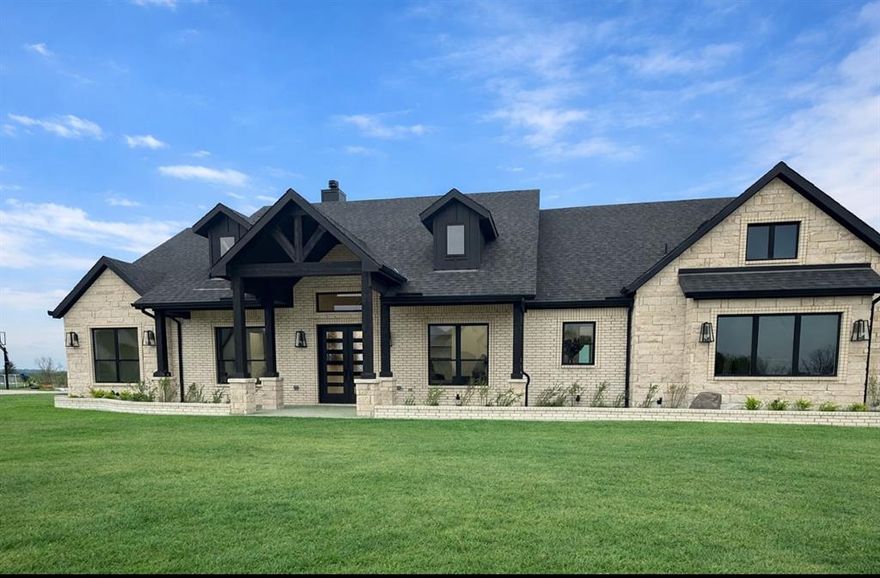 Rare offering in Sherman, Amistad Estates redefines North Texas living with expansive acreage. Welcome to 5306 Calle Drive, where modern elegance meets peaceful country living on a spacious a bit over one-acre lot. This stunning custom home offers the perfect blend of luxury, comfort, and wide-open views.
Step inside to an inviting open-concept layout filled with natural light, soaring ceilings, and warm wood flooring throughout. The living area showcases expansive windows that frame serene outdoor views and seamlessly connect to the chef’s kitchen, featuring custom inset cabinetry, quartz countertops, a large island, designer lighting, and a cooktop—perfect for both everyday living and entertaining.
The thoughtfully designed floor plan offers a private retreat with a luxurious primary suite and spa-like bathroom, featuring rain shower head in a impressive walk in shower, along with generously sized secondary bedrooms. Every detail has been carefully selected, from the elegant finishes to the high-end fixtures that elevate the home’s modern farmhouse aesthetic.
The impressive entryway makes a statement with a grand chandelier and sleek double doors, setting the tone for the sophistication found throughout the home.
Situated on a full acre, this property provides the space and freedom to create your ideal outdoor oasis—whether it’s adding a pool, workshop, or simply enjoying the peaceful Texas sunsets.
Enjoy the best of both worlds with quiet country living just minutes from town conveniences, moments from major access points, including US75, this privileged location offers a seamless balance between country side living and modern-day convenience.