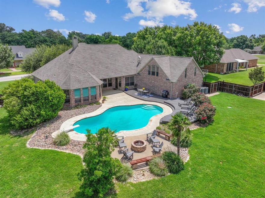 Beyond the impressive facade lies an extraordinary home meticulously crafted for those who desire the pinnacle of opulent living and breathtaking beauty.  Stepping inside onto the hand scraped hardwood floors, you are immediately struck by the airy, open concept design. The dining, living, and kitchen areas flow seamlessly with views of the gorgeous salt water pool and the outdoor living area.  The spacious primary bedroom suite provides a luxurious and private santuary boasting an exquisite en suite with a palatial tub, separate shower, individual vanities-sinks, an expansive walk-in closet, and a dedicated security closet. The second bedroom has it's own en-suite bathroom and walkin-closet, whlle the third and fourth bedrooms share a Jack and Jill bathroom with an adjoining over-sized walk-in closet. The artisan-crafted kitchen features a gas cooktop, dishwasher, split sink, walk-in pantry, vegetable sink, and a new electric oven and microwave (as of June 2025).  Stay perfectly comfortable year around thanks to three high-efficientcy, individually zoned heat pumps for heating and cooling. The water supply is provided by the city of Canton, supplemented by an owner owned filtration system. Two 50 gallon Rheem water heaters warms the water and has a recirculating pump for efficiency.  This home offers expansive living with a 300 square foot media room upstairs and a stunning outdoor living space surrounding the pool.  Beyond these amenities, the home also features an oversized three-car garage, beautiful landscaping, fire pit, storm shelter, mudroom, and a large back yard.  Every detail of this residence reflects meticulous care and timeless sophistication, inviting you to experience luxurious living.