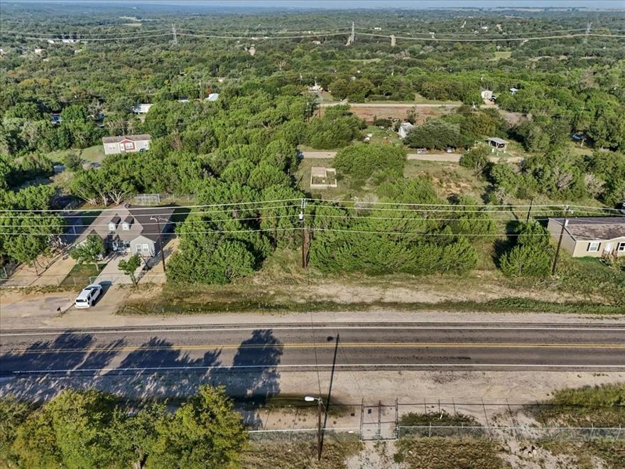Nestled just off Tin Top Hwy in sought-after Granbury, Texas, this .04-acre unimproved lot offers a rare opportunity to own a small slice of land in a prime location—without the constraints of city limits. Beautifully wooded with many trees, the property provides natural shade, privacy, and a tranquil setting that’s perfect for your future home or getaway. Enjoy the peacefulness of rural living while staying just a short drive from Lake Granbury, where you can boat, fish, or relax by the water. You're also close to shopping, dining, and everyday conveniences, making this a truly ideal location. Whether you're looking to build your dream home, a weekend retreat, or invest in land with big potential, this lot offers the best of both worlds—serenity and convenience. Don't miss out on this unique opportunity!