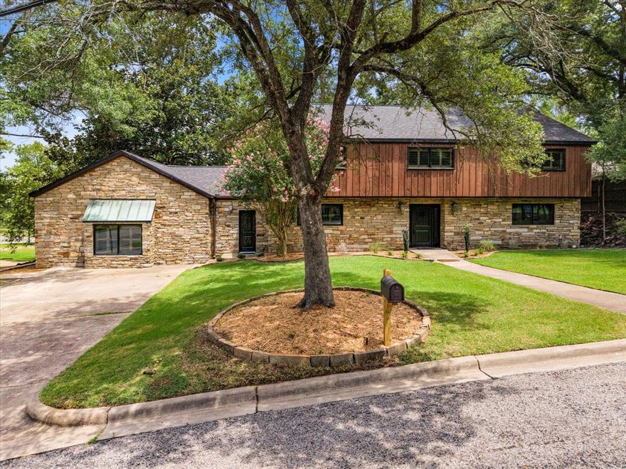 Exquisitely designed stone and cedar home sits atop a charming corner lot. Entry opens up to a gorgeous vaulted living room with stacked-stone, double-sided wood burning fireplace, leading into a massive vaulted showroom, complete with extra living area-theater room, and half bath. Custom kitchen boasts commercial oven, farmhouse sink, backsplash, marble countertops, pantry, brick flooring, and beautiful built-ins off the breakfast nook. Second entry opens to optional play-gameroom, oversized mud area, huge utility room, vault, and extra pantry-craft storage closet. Split for privacy, master bedroom has a huge walk-in closet with personal built-ins and stunning hardwood floors. Master bath includes marble counters,separate shower & tub, and abundant custom storage. Upstairs consists of large bedroom with ensuite, 2 bedrooms with jack & jill bath, and spacious office or 5th bedroom. Exterior boasts patio and fire pit space overlooking Dellwood Park. Wood shutters, cedar beams, and one-of-a-kind amenities throughout!
