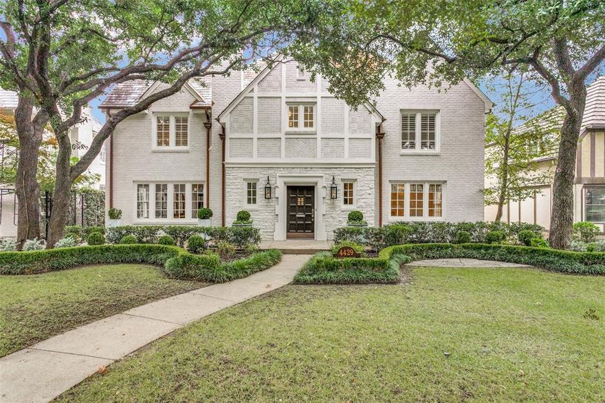 Located on coveted Beverly Drive, this architectural gem exudes sophistication. This gracious Highland Park home has been extensively updated while retaining its period charm with elegant finishes, beautiful paneling, and glass arched doors. Hardwood floors throughout complement the white art walls and moldings. The grand living room opens to the family room and nearby kitchen, which makes this a great entertaining space. With two walls of windows, natural light pours into the sunroom that leads to the chic office showcasing designer wallpaper and lighting. Upstairs, the primary retreat is spacious with a sitting area. The luxurious bathroom has a double vanity with stunning countertops, soaking tub, and shower. Three additional bedrooms and a study complete this level. The patio is outfitted with a fireplace and seating, perfect for lounging. Over the two car garage is a room and bathroom that offers flexibility as a workout space or guest suite.