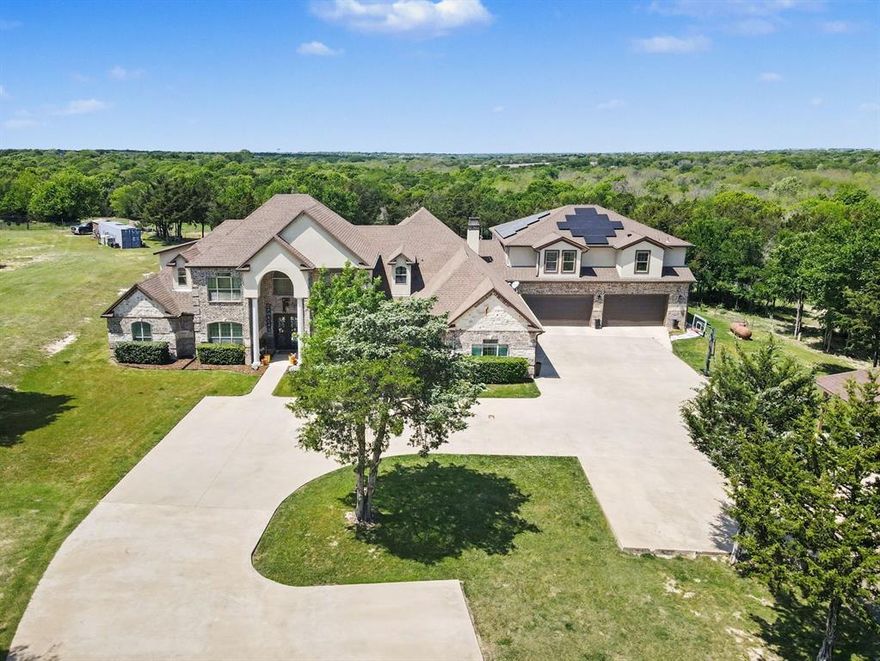 Welcome to an extraordinary estate set on 11.9 acres offering a resort style living just 17 minutes from Dallas, Texas. Designed for those who want it all, this property delivers unmatched space, luxury, and the ultimate setting for entertaining. From the moment you arrive, the scale is undeniable. Inside, the main level features three expansive living areas, each anchored by its own fireplace, creating multiple spaces to gather and relax. A dedicated office adds functionality, while the main-level primary suite offers a private retreat with an oversized spa-style bath and an expansive closet. At the heart of the home, a professional grade chef’s kitchen is built to impress, complemented by a separate guest quarters complete with its own bedroom, bathroom, kitchen, and living area, perfect for extended stays or multi-generational living. Outside, experience true resort living, an in-ground fenced pool, a covered heated patio with outdoor kitchen and seating, and an upper-level covered balcony overlooking your private acreage. Solar panels add efficiency to this already exceptional property. Ideally located near I-35E and I-20. Enjoy convenient access to shopping, dining, entertainment, and parks in Lancaster, DeSoto, and surrounding areas. This is more than a home, it’s a private retreat built for entertaining, relaxing, and living at a higher level. Opportunities like this are rare! Schedule your private tour and experience it before it’s gone. Discounted rate options and no lender fee future refinancing may be available for qualified buyers of this home. Some images are Virtually Staged