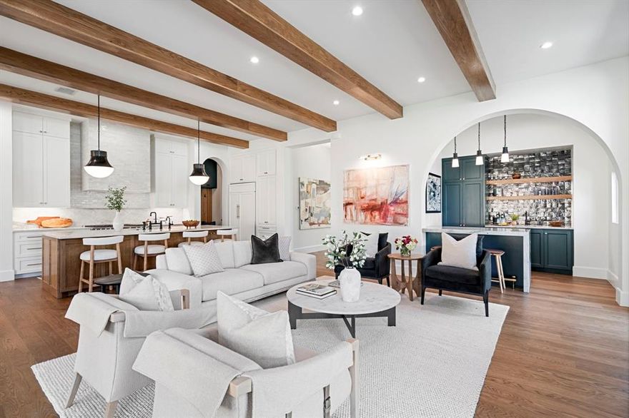 Set in the heart of Lakewood, this newly constructed residence by Midtown Partners blends architectural sophistication with everyday livability. With architectural design by Juan Carlos DeLeon, interiors by Guilded Heights Design + exteriors by Keely Landscape Design, the home offers a seamless fusion of craftsmanship, comfort, + contemporary elegance. The entry welcomes you through an impressive foyer leading to a spacious dining room with a custom built-in — perfect for entertaining. A chef’s kitchen anchors the home w custom cabinetry + gorgeous Taj Mahal Quartzite + a defined bkfst nook with custom built ins + serene views of the yard. 11 ft ceilings extend thru-out the 1st floor and into an inviting living room w a full bar featuring Magma Blue Quartzite. The primary suite is a private retreat on the 1st floor, showcasing a spa-inspired bath s dual vanities, an oversized shower, soaking tub + an impressive walk-in closet w ample storage. Upstairs, 4 spacious guest suites feature en-suite baths along w a game room + dedicated office. Exceptional craftsmanship defines every detail: white oak floors, Level 4 walls + designer lighting throughout — over $50K in fixtures from the Visual Comfort Signature Collection, as well as designer stone selections that include Blue Dunes Granite, Pristine White Quartz, and Vincent Black Granite. Oversized openings include a 10-ft front door, 16-ft patio slider + 9-ft windows - part of an $85K Lincoln window + door package that bathes the home with natural light. Built for efficiency + longevity, the home features an engineered post-tension slab w piers + retaining beams, full foam encapsulation, 3 HVAC systems, 2 tankless water heaters + an electric tank w recirculating system. This property embodies modern luxury — a masterful composition of design integrity, thoughtful materials + enduring quality. Ideally situated in one of Dallas’ most beloved neighborhoods with easy access to all the shops + dining the area has to offer.
