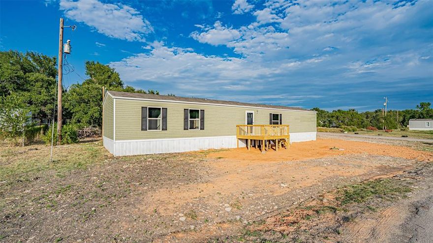 Owner financing available with $20,000 down, rate based on credit.  Newer, built in 2022 but NEVER lived in mobile home on corner lot in Oak Trail Shores.  Three bedroom, 2 bath with second living area that would be great for playroom or office.  Improved driveway and pad to the front porch.   Best to come from Tin Top for easy access.