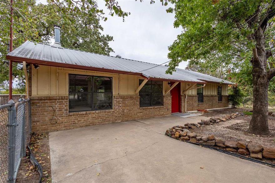 Enjoy country living with this 2 bedroom, 2 bath home on 1.45 acres, fenced and gated, situated between Granbury and Glen Rose. This neat and cozy home has a metal roof, wood burning stove, and large utility room. Outside features include a large covered patio, outdoor fire pit, and kids playset along with a 2 car carport, storage building, and workshop. Even has fruit trees! If you are looking for country living, a weekend getaway, or an investment property, this may be for you!