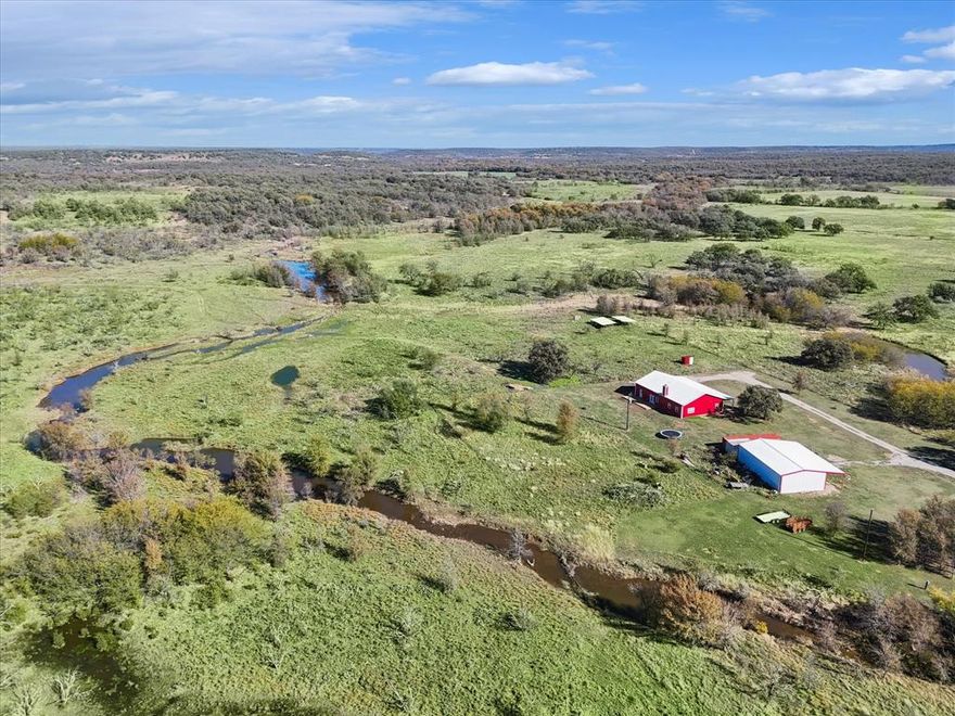 Land and Dream Ranch with a minimum of 10 Acres, a Custom Luxury 2,400 SF Barndo and Separate Shop with Dramatic elevation changes and views. The price is negotiable upwards as more land is available at only 10 K per acre extra up to 135 total acres. Choose your lot size based on your budget. This property comes with 10 stunning acres of beautiful Land, and a powerful and fresh water well, and is on the market for the first time since the year 1897.  This stunning legacy ranch includes a naturally flowing, smooth stone basin creek known for its fresh water, and it is called Lynn Creek.  This creek flows freely for many months every year, while onsite ponds have yet to run dry throughout the harshest draughts.  This spectacular and spacious family retreat includes a huge covered patio in front of a custom Norvill Barndo that has 4 Bedrooms, spray foam encapsulation, was built post 2020 with stunning kitchen, massive pantry and low electric bills.  Additionally you'll have an insulated and power packed barn with outstanding lighting and large overhead doors to house all your toys, equipment, tools and trophies.  This property also has a third barn for livestock, updated fencing in many areas and easy access throughout this Oak and Mesquite filled property.  You will be challenged to find any cedar trees as we could only find one.  Give it a look and we feel you'll see why this family has cherished this land for over 125 years.  Don't wait.