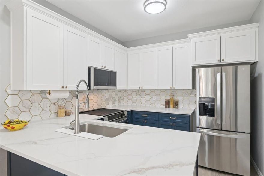 Step into refined comfort and thoughtful design in this beautifully remodeled 2-bedroom, 2.5-bath condo, ideally situated just steps from the canal and nearby hike and bike trails in Valley Ranch. Blending modern elegance with everyday functionality, this home offers a truly inviting living experience.  The fully renovated kitchen (2024) is a standout feature, showcasing white upper cabinetry paired with rich blue lower cabinets, complemented by sleek 3cm quartz countertops, a designer backsplash, brass hardware, and upgraded stainless steel appliances. The kitchen, dining and generous living area are enhanced by luxury vinyl plank flooring that flows seamlessly throughout the main level, staircase, and upstairs bedrooms, creating a cohesive and elevated feel. Upstairs, the spacious primary suite offers a cozy fireplace and a beautifully updated (2024) en-suite bath featuring an oversized walk-in shower, dual-sink vanity, modern oversized tile flooring, updated mirrors, lighting, and finishes that create a serene retreat. The secondary bedroom also enjoys its own ensuite bath, thoughtfully upgraded with modern hardware and fixtures. Additional improvements completed in 2025 include a recently installed hot water heater, solar screens on all windows for energy efficiency and privacy, an upgraded primary shower door, updated towel racks and hardware in each bathroom, and a stylish light fixture in the breakfast area. Homeowners enjoy access to a community pool, perfect for cooling off on those hot summer days, adding to the overall appeal of this beautifully maintained home ideally situated with easy access to IH-635, a variety of shopping and dining options, and approximately 15 minutes from DFW Airport.