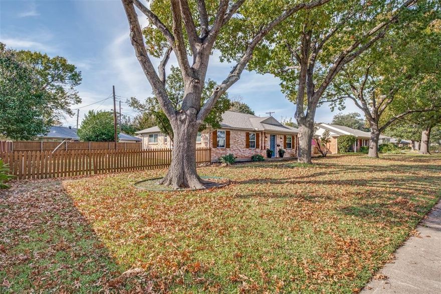 A wonderful opportunity to own a well cared for home on .23 ACRE with mature trees in sought after Lake Highlands North and priced to allow new owners to add their updates. Whether you are buying for the first time or down sizing, this property could be the perfect fit. The expansive lot will provide space to expand the foot print of the home. NEW ROOF 2025 AND Exterior Paint. Spacious Bedrooms, each with their own Ensuite featuring ceramic tile floors, have been UPDATED with FRESH PAINT and NEW CARPET. The living room with newer rich engineered hardwood flooring and brick gas fireplace is open to the dining and kitchen. Kitchen area w island has ceramic plank flooring and cabinets are light in color and not original. Two car attached garage has entry to kitchen. The rear exterior of the home has been enhanced with an additional covered parking area as well as a remote control rear entry privacy gate providing additional security. Yard is big and allows for extending the outdoor living to accommodate a pool, work shop or playground structure. HVAC system has been replaced within the past ten years. Nest thermostat added. Windows have been replaced too.