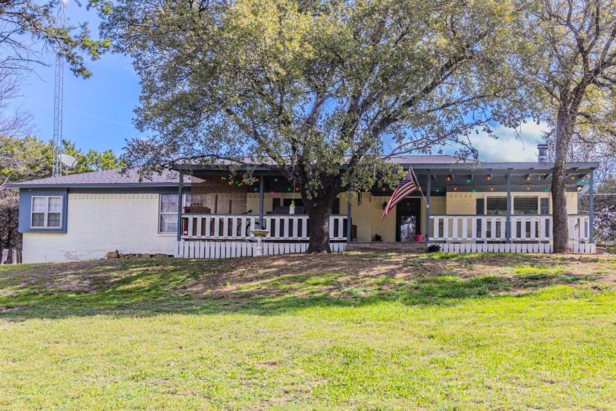 Are you looking for quiet country living without a lot of upkeep? This almost 1 acre lot with an updated 3 bedroom 2 bath home is situated in the China Spring School District on a paved road. When you first approach the home, you see it positioned on a sloping hill back from the road. A large live oak tree shades the covered front porch that stretches across the entire front of the home. Plenty of room to sit and enjoy the peaceful sounds and the fresh country air! Entering the front door off the porch, you have a large open-concept living, dining and kitchen area. Equipped with a wood burning fireplace and plenty of windows for light, this area provides a great area to gather, eat and enjoy time at home. The extra large primary bedroom has extra space for an office area, workout equipment or whatever is desired. The primary suite bathroom is also large with a separate tiled shower, large tub, double sinks and a large closet. There is a second closet in the primary bedroom as well. The other 2 bedrooms share an updated hall bathroom with close proximity to both bedrooms. Outside you have a covered carport for 2 cars beside the home, a large portable storage shed that stays with the property and a spacious yard for outdoor activities. The lot goes all the way to the middle of the seasonal creek for some shaded respite from the summer heat. Call today for an appointment to see this well cared for property!