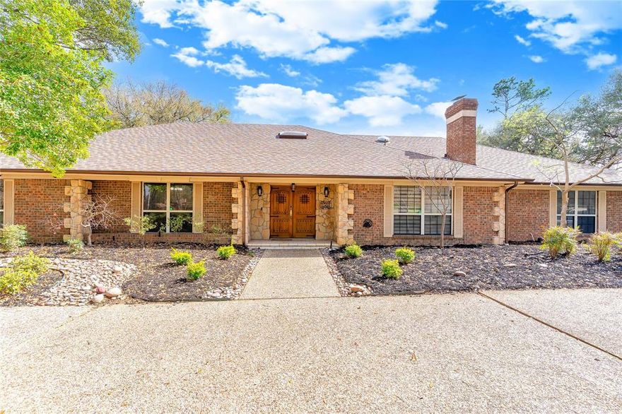 OPEN HOUSE SUNDAY 4.17.26 - 1:00-3:00.  This warm and inviting 4-bedroom, 3-bath home sits in a gorgeous, well-established neighborhood surrounded by mature trees and beautifully maintained landscaping. The curb appeal is unmatched with a circle driveway, 3-car garage, and brick fencing around perimeter.
Inside, the home offers room for everyone with two living areas, including a brick gas fireplace. The main living area, kitchen, and entryway all feature brand-new skylights that bring in incredible natural light, along with updated lighting fixtures and ceiling fans that give the home a fresh, modern feel.
The secondary suite with its own full bath creates a fantastic setup for an in-law suite, guest retreat, older teen, or multi-generational living.
A standout feature is the classic wood-paneled library, complete with rich wood flooring, and custom built-ins perfect for work or quiet evenings. The kitchen is designed for busy families, offering an abundance of cabinetry along with two dining areas ideal for everyday meals or gatherings.
For those who love to entertain, the wet bar opens directly to a large back patio, perfect for hosting—or easily transformed into a trendy at-home “speakeasy,” a design feature making a comeback. Step outside to enjoy the heated pool and hot tub, complete with safety fencing and surrounded by established, lush landscaping for privacy and relaxation.
This home blends character, functionality, and thoughtful updates in a location buyers love.