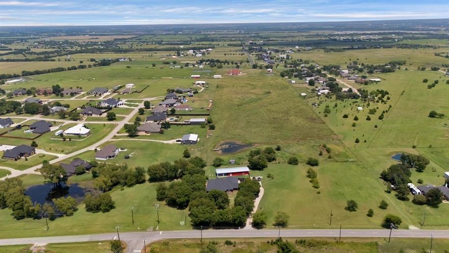 Rare 2+ acre one-story custom home in Forney offering space, privacy, and convenience near major shopping and dining. This thoughtfully designed 4-bedroom, 3 full bath home provides 3,414 square feet of true single-level living in a peaceful country setting just minutes from Costco, H-E-B, and everyday amenities, with an easy 45-minute commute to downtown Dallas.
Situated on just over 2 acres of land with NO HOA, the property offers room to live, work, entertain, and enjoy outdoor living while remaining close to Forney’s expanding retail corridor.
Designed for comfortable one-story living, the functional floor plan includes private bedroom separation, a dedicated office with double doors, and convenient laundry access directly from the wrap around primary closet. The open-concept living area features a spacious family room with fireplace flowing into the kitchen with custom wood cabinetry, double wall ovens, gas cooktop, and generous prep space ideal for gatherings and everyday living.
A rare walk-up attic with full staircase and door access provides exceptional storage and future flexibility rarely found in one-story homes. Hard-scraped wood flooring runs throughout. 
Outdoor living includes a 25x25 covered patio overlooking open acreage and wide Texas skies. The impressive 25x50 workshop with electricity provides outstanding flexibility for hobbies, projects, or equipment storage. The long driveway offers extensive parking with room for RVs, trailers, and guests, along with an oversized three-car garage.
Major updates include roof (2022), water heater (2023), and HVAC (2025). Buyers seeking space, privacy, and flexibility will appreciate the rare combination of acreage, functional single-level living, and convenient access to Forney’s rapidly growing retail, dining, and commuting corridors.