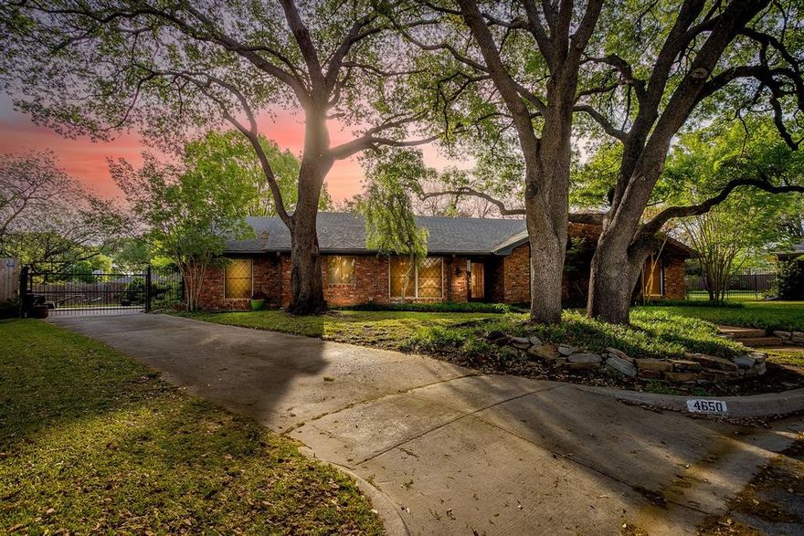 Welcome to 4650 Flat Rock Court. This impeccable home is perfectly situated on a tree lined cul de sac lot in Overton South. Designed for both comfort and entertaining, this 4-bedroom, 3 full bathroom single story residence features over 3200 sq ft of luxurious living. The primary living room is highlighted by striking wood beams, a beautiful fireplace, and a dry bar. French doors bring in natural light throughout this home. Saltillo tiles adorn the hallways for a touch of durability and warmth. The galley style kitchen boasts bright windows, updated LED lights, abundant cabinets and built ins, a wine fridge, a pot filler, and an appliance garage. The island cart is completely moveable to accommodate your prep and presentation needs in the kitchen. Each bedroom here is generously sized and you will not lack for storage. Built ins and closets are all perfectly placed throughout. Primary ensuite includes 3 fantastic closets, window shutters, split vanities, a toilet room, and a large walk in shower. Guest bedrooms 2 and 3 are adjoined by a Jack and Jill style bathroom with jetted spa tub, oversized vanity and cabinet storage. Bedroom 4 is on the opposite wing of the home and is adjacent to a full bathroom with walk in shower. A large bonus room features incredible windows, french doors, an office nook, a great closet and a photography dark room. Bonus room could flex as a 5th bedroom if needed. Outside, enjoy the privacy of a gated driveway leading to a side-entry garage, oversized parking pad, lush courtyards, mature landscaping and trees, and a charming potting shed. A fenced side yard is a great option for your pets. This rare find is an incredible opportunity at an incredible price. Welcome home.
