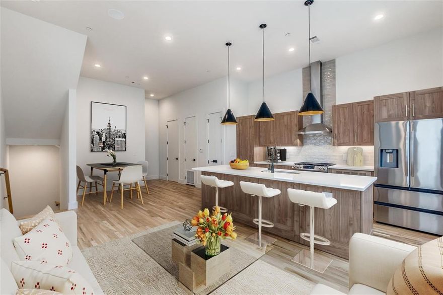 Offering 1 month free with 15 month lease.  This luxury townhome community from The Collection features high-end finishes, a smart home package & superior energy efficiency. Welcome home to your end-unit townhome, with a dedicated office space & a two-car garage on the first level. Head upstairs to the expansive living spaces with an open floor plan, complemented by beautiful hardwood floors & soaring windows that flood the rooms with natural light. Enjoy the chef’s kitchen, equipped with an island, stunning wood cabinetry, quartz countertops, pantry & high-end appliances. Retreat to the primary suite, where vaulted ceilings, a spacious bedroom, a walk-in closet & a spa-like bath await. Effortlessly manage your smart home with the Brilliant Smart Home hub or app, allowing you to control lights, the Ring doorbell, Ecobee thermostats & built-in Sonos speakers with ease. Located near some of the city's finest bars, restaurants, shops, & park. Photos may not be of exact unit but are comparable floor plan and finish