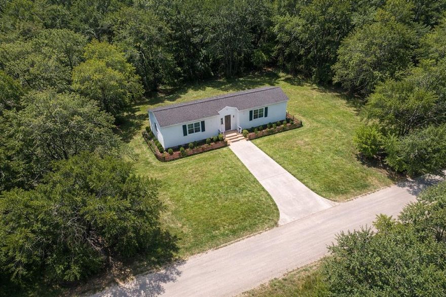 Tucked away in a peaceful, tree lined neighborhood, this lot offers a perfect setting to build your dream home or investment property. Conveniently located just minutes from Lake Granbury with easy access to shopping, dining, and the lake.  ANY Photo's displaying a home are an Artistic Concept and there is no Home on the property. Seller nor listing agent Do Not have blueprints or designs since this is an Artistic Concept of the possibilities that could be possible with this property.