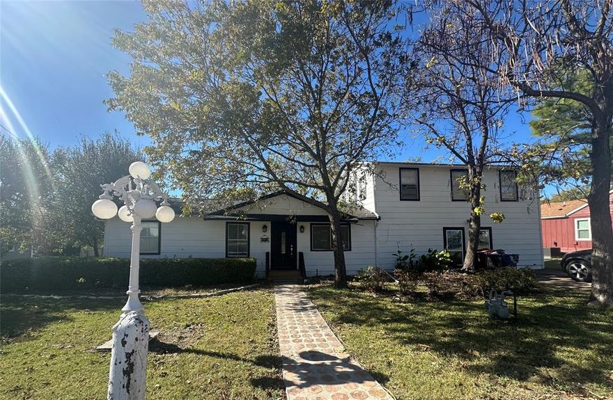 This classic Texas, two-story home is situated on a main street with a great location near the historical downtown of Royse City.  It blends small-town warmth with timeless character, with 4 bedrooms, 2400 sq. ft.. It's nestled on a spacious lot, over 15,000 sq. ft., shaded by mature trees, a brick walkway leading to a welcoming entry.  The back of the home includes a large enclosed porch, a large back yard with plenty of room for outdoor entertaining gardening, or playtime under the canopy of established trees, and a storage shed for all your extra tools.  A charming vintage-style lamppost adds to the nostalgic appeal of this home, making this home stand out on a quiet residential street just minutes from downtown shops, nearby school and parks.  The primary suite is upstairs and three other bedrooms are located downstairs.  This home was originally built in 1972, and is ready for a refreshing update.  This is your chance to purchase a charming Texas home in a great location, and update it how you'd like.  Home is priced according to current condition, sold as is and no updates will be completed.  Sellers have no survey.