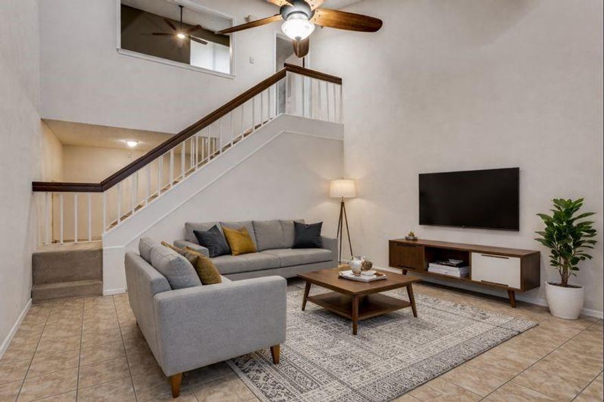 Back on market! This condo is ready for its new owner.  You'll enter in through the mid century modern front door to the spacious and open first level, finding the kitchen, laundry and guest bath are tucked away, but still bright and airy with large windows.  The living area boasts massive 20ft ceilings, see through stair case and skylights for lots of natural light. From here, this leads you out to your private outdoor space with storage closet, perfect for grilling and enjoying the fresh air. The whole living space is tied together with pristine tile floors and brick fireplace. Upstairs is the primary suite and en suite, with large, mirrored closets, tiled shower and large frosted window. Open window to first floor can easily be closed off.  Community backs up to a creek and wooded area, and also hosts a community swimming pool.  Condo comes with one assigned covered parking spot right in front. Stop by today and see how you can make this property your unique home.