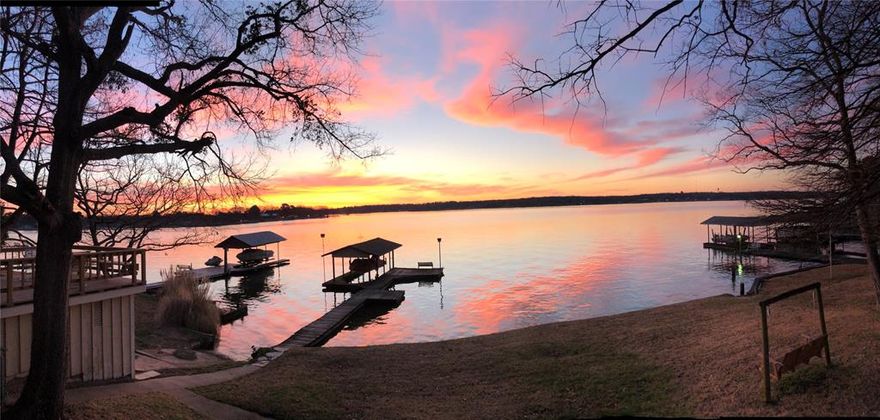 Beautiful open water with breathtaking views! 1.5 lot (more or less) with mature trees. Single slip boat dock. 3 bedroom house with 2 living areas (one could make a perfect formal dining). Nice, one street neighborhood. Perfect Weekend Getaways as it is or a premium lot for an estate development. Price reflects needed repairs-updates.