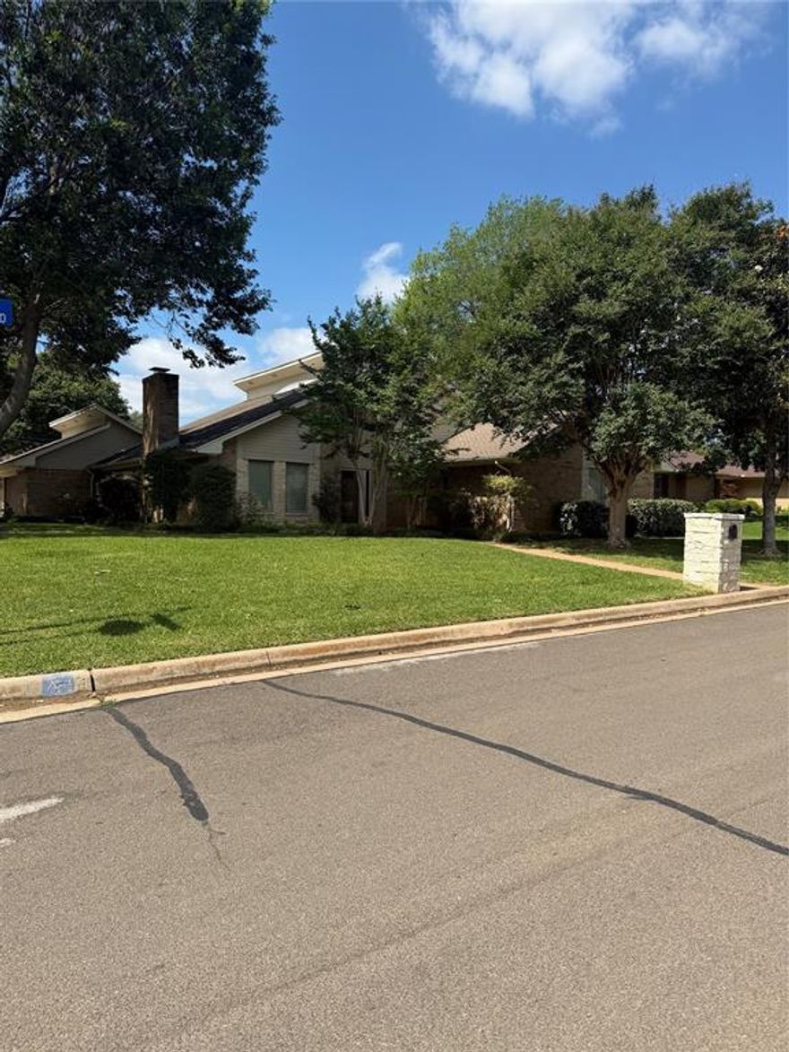 Tucked into established Meadow Park Estates with no HOA, this 2,266 sq ft original-owner home sits on a large 0.22-acre corner lot with a side-entry two-car garage. Replacement windows throughout, a brand-new roof currently being installed by the seller, fresh interior paint, new front and interior doors with updated hardware, and a new insulated garage door deliver real efficiency and modern curb appeal. The living area features a wood-burning fireplace and hand-scraped hardwoods that continue into the dining room. The kitchen has been refreshed with quartz countertops, painted cabinetry, new appliances, and new ceramic tile. New carpet runs through the family room and three bedrooms, and travertine flows through the entry and bathrooms. Two full baths plus a half bath positioned for direct pool access — built for North Texas summers around the large diving pool. New primary bath vanity cabinets and an app-controlled full sprinkler system round out the updates. Less than a 10-minute walk to River Legacy Park South and the River Legacy Science Center, and minutes to the Arlington Entertainment District. Full upgrade list available. Buyer to verify all measurements and features.