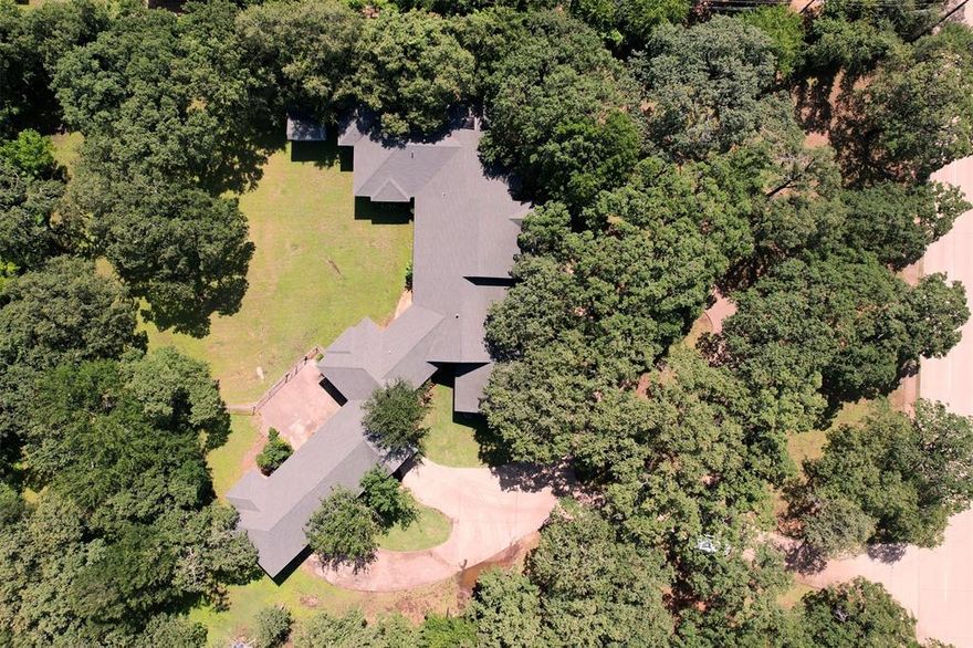 2 HVAC UNITS INSTALLED JUNE 2025!! Welcome to a truly one-of-a-kind property that perfectly blends the serenity of country living with the convenience of city amenities. Nestled on just over 2 picturesque acres, this meticulously maintained home is surrounded by majestic 200-year-old live oak trees, providing ample shade, natural beauty, and a peaceful retreat teeming with birds and wildlife. Thoughtfully remodeled and expanded in 2002, every inch of this home reflects pride of ownership and attention to detail. Inside, you’ll find a wide range of features designed for comfort and functionality, including cedar-lined closets, an exquisite custom library, a dedicated exercise room, and a spacious laundry room. The open living spaces are filled with natural light, creating a bright, airy, and welcoming atmosphere throughout. Storage is abundant, with clever built-ins and ample closet space to keep everything organized and out of sight. The heart of the property is a massive shop with 3-phase electric—perfect for hobbyists, woodworkers, car enthusiasts, or anyone in need of a versatile workspace. There's also a paved circle driveway, and beautifully maintained landscaping that adds to the property’s charm and curb appeal. Conveniently located with easy access to major highways, shopping, dining, and entertainment, this home offers the rare opportunity to enjoy the privacy and space of a rural setting without sacrificing modern convenience. Whether you're entertaining guests, working on a passion project, or simply enjoying the view from your shaded patio, this property is the perfect place to call home. Don’t miss your chance to own this peaceful slice of paradise with unmatched charm, character, and versatility. Schedule your private tour today and experience all this exceptional home has to offer!