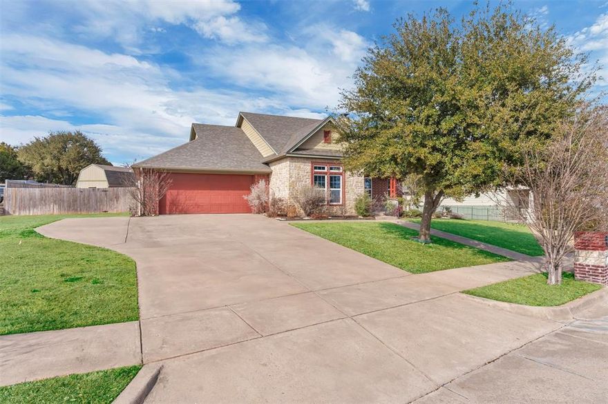 Located in the highly sought-after Camelot subdivision, 125 Camelot Street in Glen Rose offers comfort, accessibility, and thoughtful design on an oversized one-third acre lot. Built in 2009, this 3 bedroom, 2 bathroom home features 2,048 square feet of well-planned living space in the highly acclaimed Glen Rose ISD.

The attractive brick and rock exterior is complemented by mature landscaping and a full sprinkler system. Inside, the functional layout includes wide hallways and accessibility-friendly features providing ease and comfort for everyday living.

The kitchen offers a walk-in pantry, ample cabinetry, black granite countertops, and a built-in desk area just off the kitchen that works perfectly as a home office, homework station, or planning space. A large laundry room adds everyday convenience.

The living area is anchored by a cozy wood-burning fireplace, creating a warm and inviting gathering space. Step outside to enjoy the screened back porch, ideal for morning coffee or relaxing evenings.

This energy-efficient home is equipped with foam insulation and UCS electric service to help keep utility costs low. Additional highlights include stairway access from the garage to attic space, offering excellent storage or the potential for future finished living space.

The backyard features a 360 square foot storage building with electricity and lighting already in place, perfect for a workshop, man cave, she shed, or creative project space.

A well-maintained home offering space, efficiency, accessibility, and flexibility in one of Glen Rose’s most desirable neighborhoods.