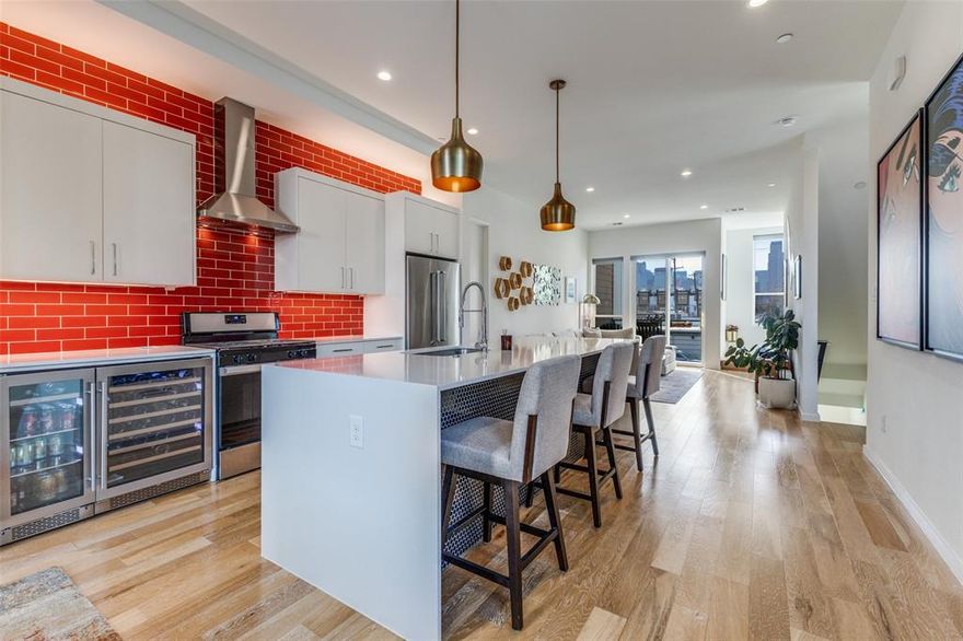 2-1 RATE BUY DOWN offered by Seller with acceptable offer.  Experience sophisticated urban living in this stunning 3-story contemporary condo, built in 2020. This impeccably maintained 3-bedroom, 2.5-bathroom residence features an open-concept second floor with soaring 14-foot ceilings, oversized windows for abundant natural light, & a private epoxied balcony (no harsh concrete). The gourmet kitchen is a chef’s dream, boasting quartz waterfall countertops, custom tile backsplashes, premium stainless steel appliances (Whirlpool dishwasher and 20.0 Cu. Ft. KitchenAid Refrigerator), Zephyr 15-inch undercounter beverage center and Zephyr Wine Cooler, walk-in pantry & a gas range. Includes an LG washing machine and LG dryer. The third floor hosts a spacious primary suite with a spa-inspired ensuite featuring dual vanities, professionally wired and installed towel warmer, huge shower, & a walk in closet, along with a secondary guest suite with en-suite bath. Highlights include attached 2-car fully-epoxied garage, MyQ smart garage system, finger-print locks, custom Shade Store blinds throughout w a remotely-operated electronic main shade on 2nd floor, new carpet throughout, front door treated w sunblocking protection, luxury upgrades including a Toto Neorest Washlet and Toto Neorest toilet professionally installed, garage & patio floor epoxied & professionally hardwired Ring security cameras in both front & back of unit. New carpet on the 3rd floor. The third bedroom is on first floor & is versatile office or bedroom. Hot water heater anode rod replaced in Q4 25 & air conditioning capacitor replaced and refrigerant topped up in Q3 25. Located mins from Deep Ellum, Uptown, Lower Greenville and Exall Park. Outside trees provide privacy and bring nature to you w nesting birds; fall colors are spectacular. The HOA covers water, sewer, trash, and exterior maintenance. A true lock-and-leave gem in a premier Dallas location. Walk in, unpack, unwind, entertain and enjoy it all