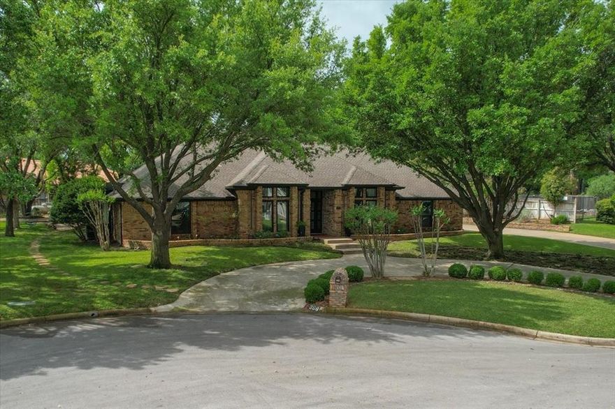 This retreat has been curated and remodeled with specific attention to building material type and content, offering one of a kind designer style and high end improvements.  The tranquil home is large enough for entertaining yet cozy enough for you to relax and feel at ease. The home is 3587 sf with 4 bedrooms, 3 full baths, 2 fireplaces, a spacious office living area or use as a 5th bedroom, along with a huge walk in attic, & a 2 car attached garage.  Primary bedroom, sunroom, office, kitchen and 2 additional bedrooms all have views of Eagle Mountain Lake. Indoor & outdoor spaces blend seamlessly and will make you excited to see what is next. The large windows are crafted to showcase the stunning sunrises & sunsets visible over Eagle Mountain Lake. This is the perfect way to start and end your day. The custom bathrooms are of high end design.  The home is nestled across the water from the Fort Worth Boat Club and gives viewers fun visuals during the sailing regatta season. The affordable HOA provides a community fenced pool, a boat launch, and boat docks in your cul-de-sac for immediate use. See the transaction desk for the list of HOME FEATURES  to discover many of the over $400,000.00 worth of improvements and custom upgrades.  The circular drive offers 3 parking spaces and 6 parking spaces on the side driveway.  Showings will begin April 28th.