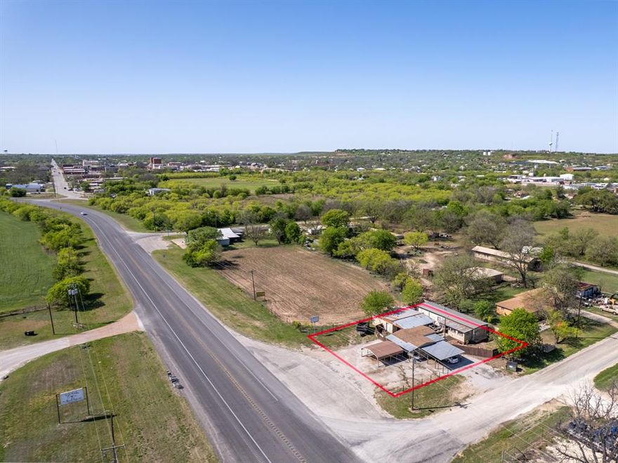 Live and work in the same place! Single-wide mobile home with a shop and office, on a corner lot with highway frontage. Nice, privacy-fenced yard with a deck and sun porch. The 27x22 shop is currently being used for small engine repair, but could be repurposed to fit your needs. Storage could be turned into an office space.