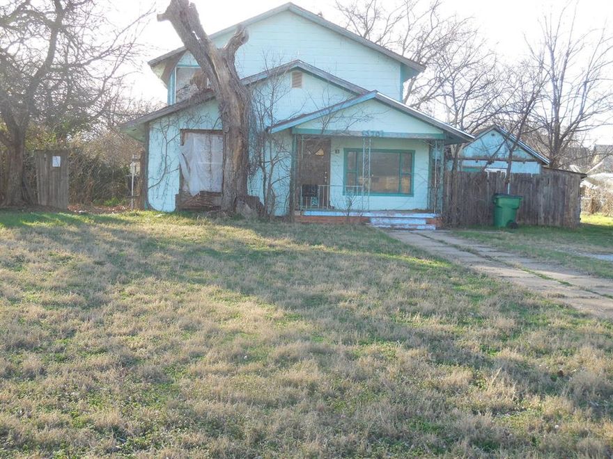 Don't miss this home on a large lot close to downtown. This 3 bedroom, 2 bath, 1.5 story home present a unique opportunity for those seeking a project with significant upside. The property will require repair, offering a blank canvas for renovation and customization to maximize future value.  Attached garage has been converted into a workshop and storage area. A large, fenced backyard offers plenty of room for activities for family fun and pets to explore. Location offers a short walk to the courthouse square, grocery store, and other shops. Call today for more information and your personal tour.